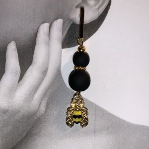 Drop Dangle Bee Pendant Earrings hang from Gold Tone Post and Black Beads